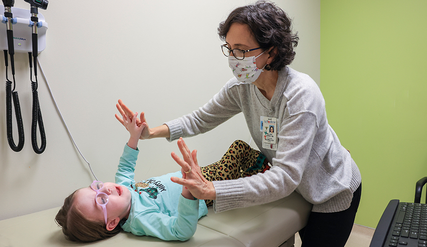 Dr. Elena Caron with a patient in the MDA clinic